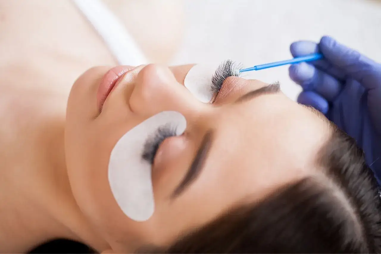 Profesjonalna henna rzęs dla pięknego spojrzenia. Stylistka precyzyjnie aplikuje produkt.